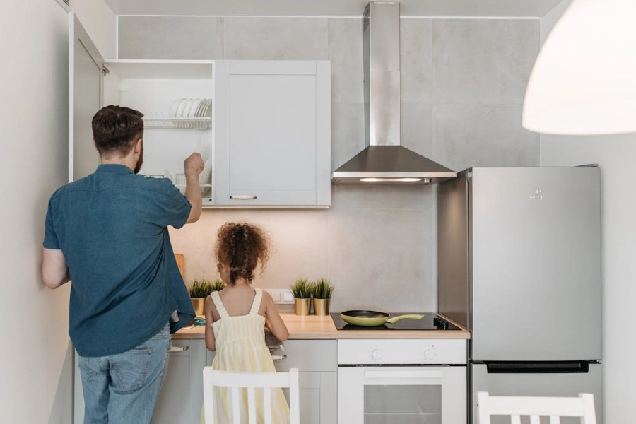 a daughter and a father in the kitchen